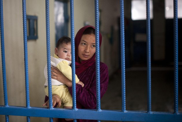 Picture taken March 28, 2013 shows Afghan female prisoner Nuria with her infant boy at Badam Bagh, Afghanistan's central women's prison, in Kabul, Afghanistan. “When I went to court for the divorce, instead of giving me a divorce, they charged me with running away,” Nuria said. The man she wanted to marry was also charged and is now serving time in Afghanistan's notorious Pul-e-Charkhi prison. 202 women living in the six- year- old jail, the majority of the women are serving sentences of up to seven years for leaving their husbands, refusing to accept a marriage arranged by their parents, or choosing to leave their parent's home with a man of their choice. (AP Photo/Anja Niedringhaus)